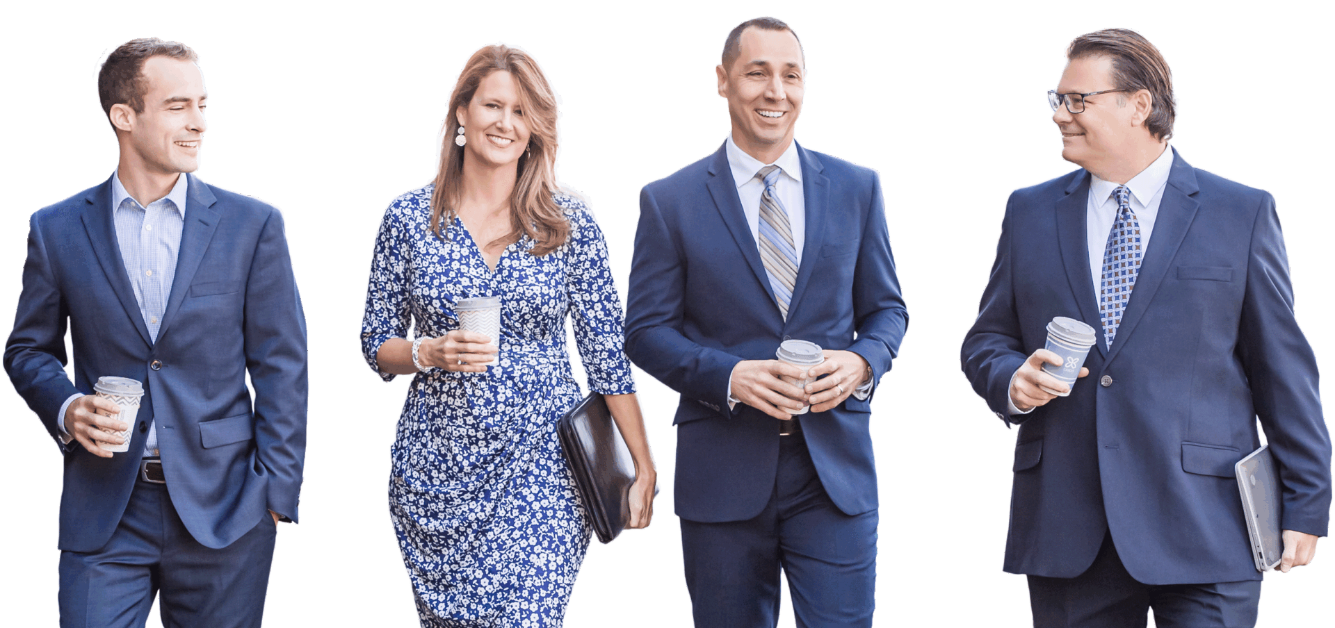 Four professionals walking with coffee cups.