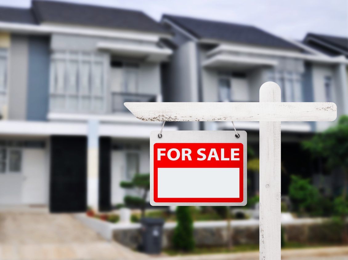 House with a "For Sale" sign.