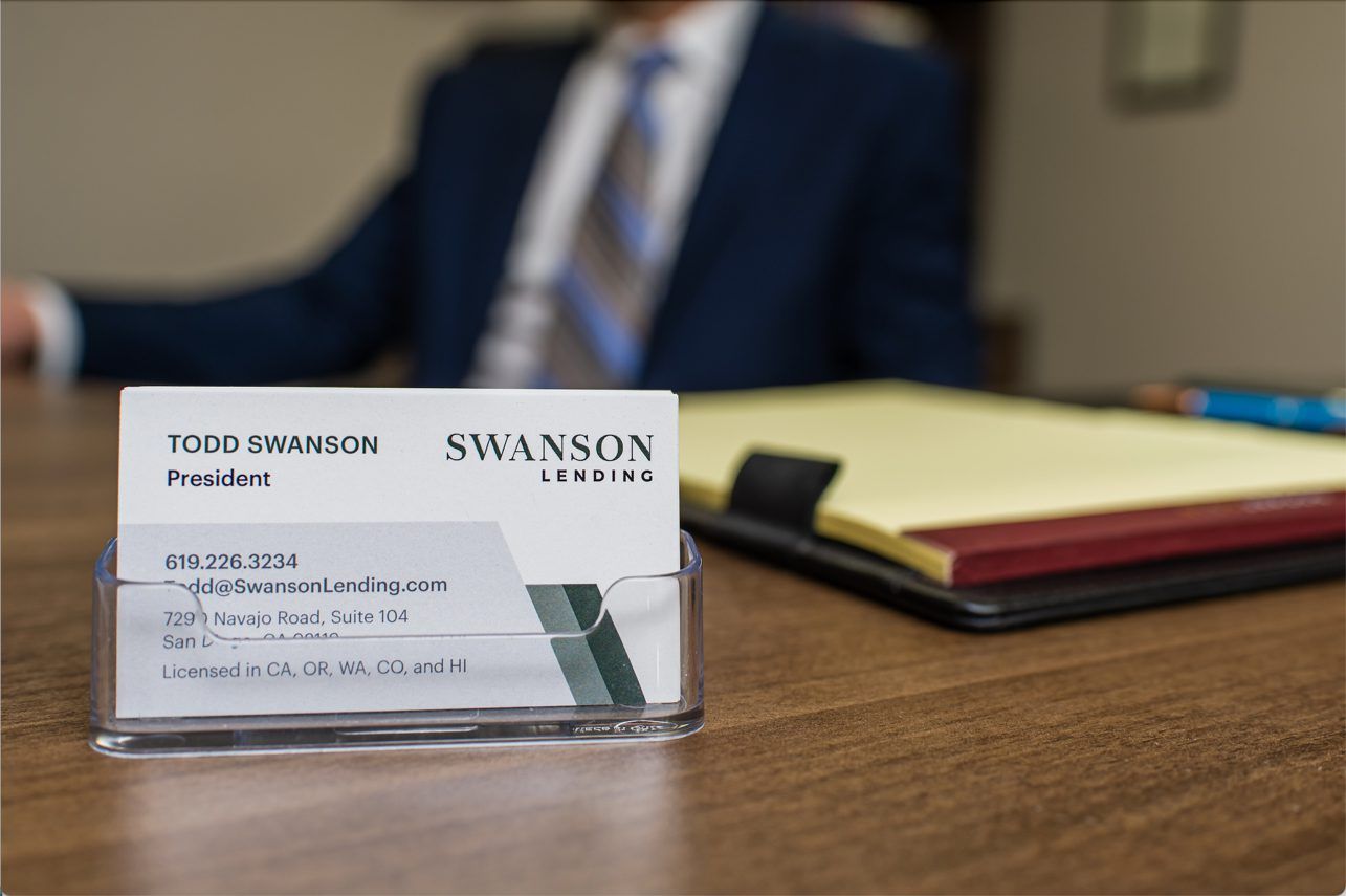 Business card holder on a wooden desk.